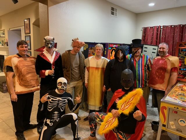 The whole group lined up in Halloween costumes for a team photo